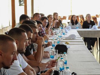 the asioso team sits at the table during the workshop